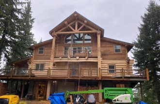 This is a big job! Nearly 40 feet to the top of the overhang. We also blasted and sanded and stained the cedar siding.